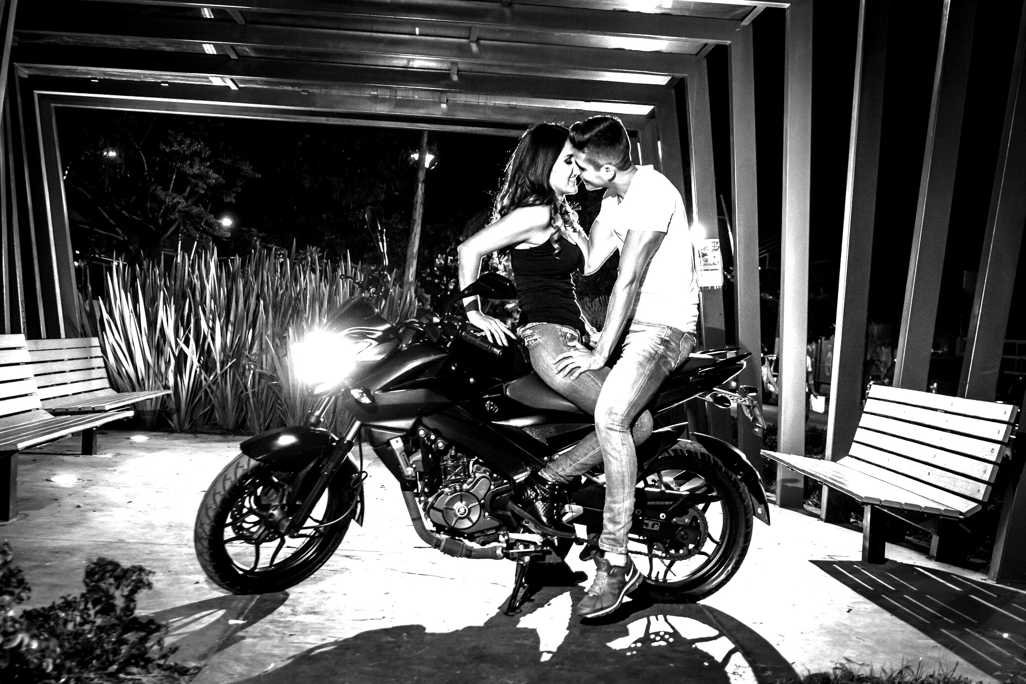 Couple Hugging While Sitting on Motorcycle